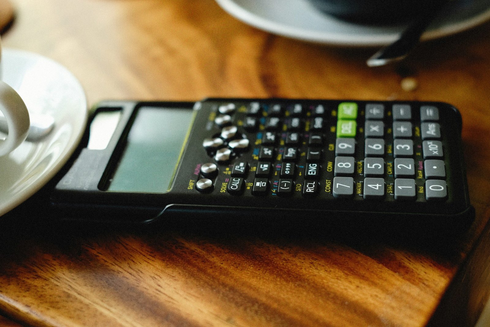 A calculator, a house model, and financial spreadsheets