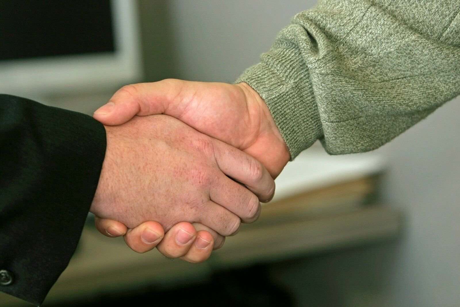 We buy houses legit: A handshake symbolizing a trustworthy home buying deal
